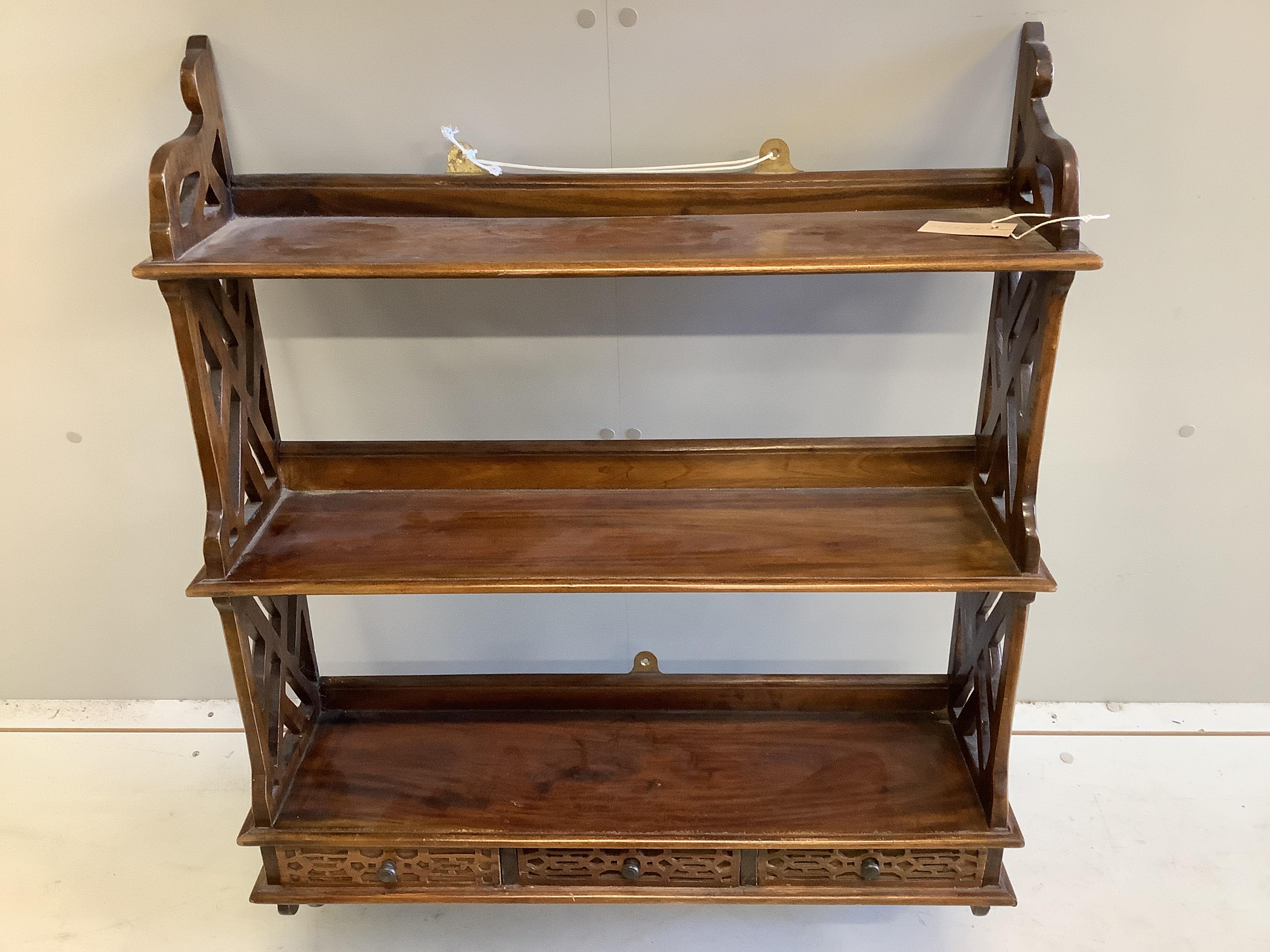 A pair of George III style mahogany three tier wall brackets, width 72cm, depth 20cm, height 92cm